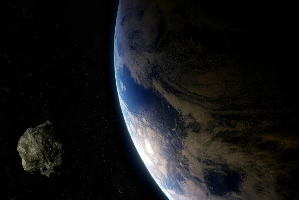 Foto referencial de un asteroide y del planeta Tierra.
