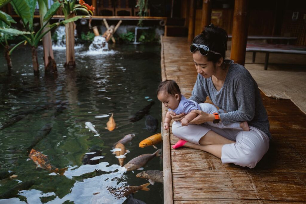Imagen referencial de una madre que ve peces con su hijo.