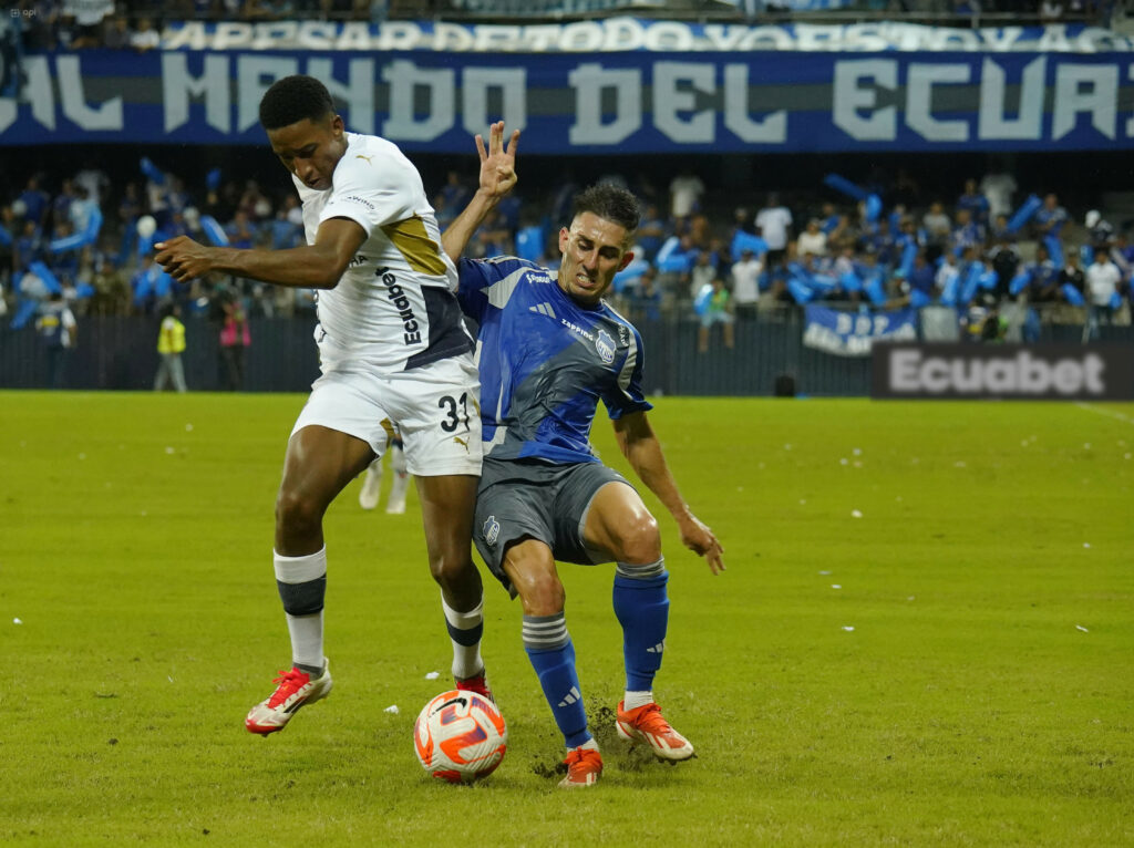 Jugadores de Liga y Emelec disputan un balón en la Liga Pro.