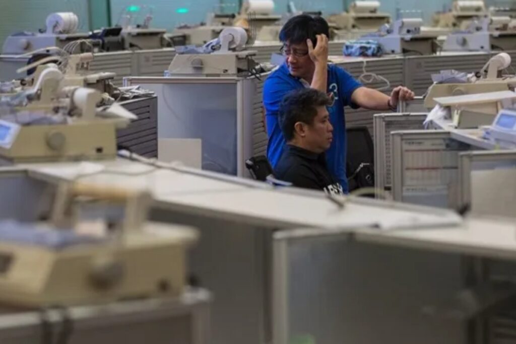 Dos corredores de bolsa trabajan en la sala de operaciones de la Bolsa de Hong Kong, en una imagen de archivo. Foto: Archivo EFE