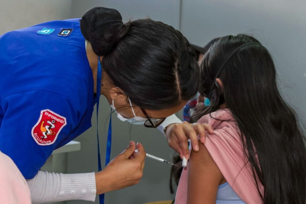 Personal médico vacunando a un estudiante.